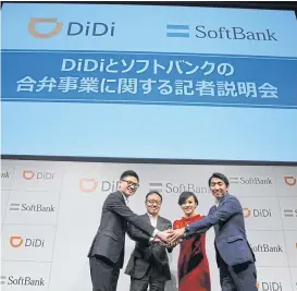  ?? AP ?? Didi Chuxing and Softbank Mobile Corp executives shake hands during a press conference announcing their joint venture in Tokyo yesterday.