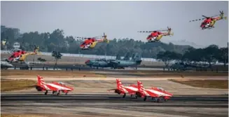  ?? ?? HAL-built Hawk Mk.132s of the Surya Kiran formation aerobatic team taxi out as HAL Dhruv ALHs of the Sarang team get airborne for their respective displays