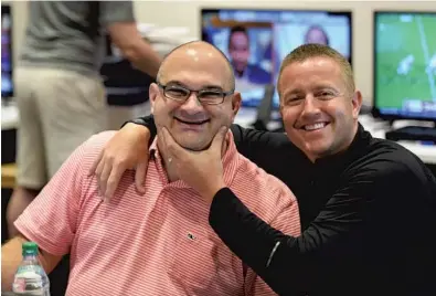  ?? SCOTT CLARKE / ESPN IMAGES/COURTESY ?? Chris Fallica, left, gets some help mugging for the camera by Kirk Herbstreit in a production meeting for College GameDay. Both of them have worked on the show since 1996.