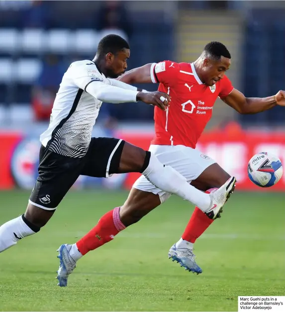  ??  ?? Marc Guehi puts in a challenge on Barnsley’s Victor Adeboyejo