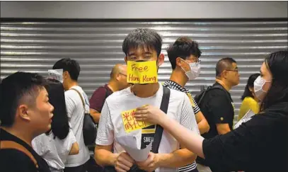  ?? Lillian Suwanrumph­a AFP/Getty Images ?? PRO-DEMOCRACY protests in Hong Kong can be difficult to comprehend for those raised on mainland propaganda.