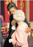  ??  ?? Mrs Obama embraces the Queen in 2009