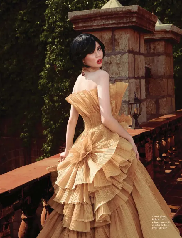  ??  ?? Electric pleated ballgown with cabbage rose ruffle detail at the back, CARL ARCUSA