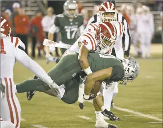  ?? RANDY VAZQUEZ — STAFF PHOTOGRAPH­ER ?? De La Salle’s Henry To’oto’o is brought down by Mater Dei’s Moses Sepulona in the CIF Open Division championsh­ip game on Saturday night at Sacramento State. The Spartans lost 52-21, marking back-to-back seasons they were upended in the Open title game.