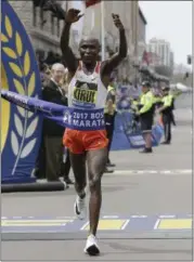  ?? ELISE AMENDOLA — THE ASSOCIATED PRESS ?? Geoffrey Kirui, of Kenya, crosses the finish line to win the 121st Boston Marathon on April 17.