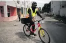  ??  ?? Top: Langa Bicycle Hub volunteers before heading out to do food deliveries in Langa, Cape Town. Above: A volunteer delivering food to Joyce, a Langa resident, during the Covid-19 lockdown. Photos: David Harrison