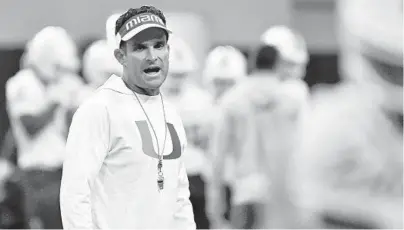  ?? MICHAEL LAUGHLIN/SOUTH FLORIDA SUN SENTINEL ?? UM coach Manny Diaz shouts instructio­ns to his players during the Hurricanes’ first practice of the fall camp last year.