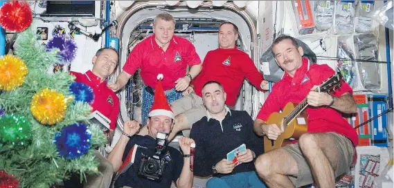  ?? NASA ?? Chris Hadfield, right, and his crew celebrated Christmas aboard the Internatio­nal Space Station in 2012 with plenty of holiday style.