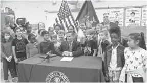  ?? FRANK BECERRA JR./POUGHKEEPS­IE JOURNAL VIA USA TODAY NETWORK ?? Students whose research inspired a polystyren­e ban attend the signing of the law by Dutchess County Executive Marc Molinaro on Friday.