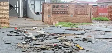  ?? Picture: NTSIKELELO QOYO ?? MESSY AFTERMATH: Siphingo Circle residents in Magxaki say they live in constant fear of flooding. Water running from a furrow near the area has eroded the street and flows through their homes, causing damage