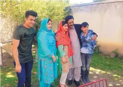  ?? ABDULLAH SHERIN/ASSOCIATED PRESS ?? Pakistan’s Nobel Peace Prize winner Malala Yousafzai, center, is with her family at their home during a visit to Mingora, in Pakistan’s Swat Valley, on Saturday, for the first time since a Taliban militant shot her in 2012.