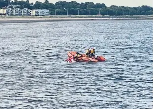  ??  ?? The crew of the inshore lifeboat recovering the stricken jet ski.
