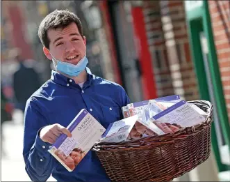  ?? MATT STONE / HERALD STAFF FILE ?? Danny Coakley of North End Waterfront Health gives out free COVID-19 test kits outside of their North End site on March 11.