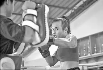  ??  ?? Nong Rose doing pad work during a training session.