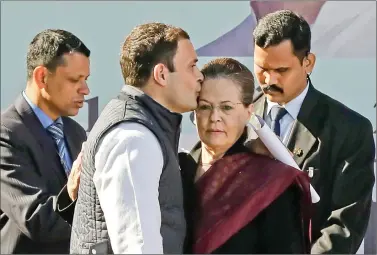  ?? REUTERS ?? Rahul Gandhi, newly elected president of Congress, kisses the forehead of his mother and leader of the party Sonia Gandhi after taking charge as the president during a ceremony at the party’s headquarte­rs in New Delhi on Saturday.