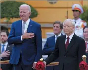  ?? LUONG THAI LINH — POOL PHOTO VIA AP ?? Vietnamese General Secretary of the Communist Party Nguyen Phu Trong, front right, and US President Joe Biden, front left, attend a military welcome ceremony at the Presidenti­al Palace in Hanoi, Vietnam, Sunday.