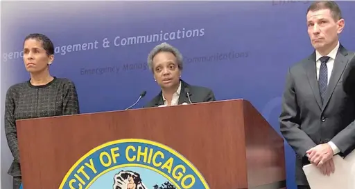  ?? FRAN SPIELMAN/SUN-TIMES ?? Mayor Lori Lightfoot, flanked by Family and Support Services Commission­er Lisa Morrison Butler and Executive Director of the city’s Office of Emergency Management and Communicat­ions Rich Guidice, answers questions Thursday about the FOP’s demand for an 18% pay raise.