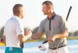  ?? JIM RASSOL/STAFF PHOTOGRAPH­ER ?? Playing partners Sergio Garcia, left, and Adam Scott congratula­te each other after the 3rd round Saturday. The two finished in a tie for first, four shots clear of the field.