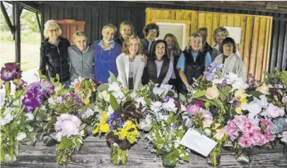  ?? BY ANITA OSTRANDER ?? Volunteers at Rappahanno­ck County Garden Club Bouquet Design event in 2021:
Front row L-R: Karen Crow, a volunteer visitor, Charlotte Templeton, RCGC President Kathi Dutilh, Denise Ford, Ruth Welch, Katie Burney
Back row: Lindy Klaus, Susan Jones, Darcy Justen, Julie Stanton, Carolyn Walker.