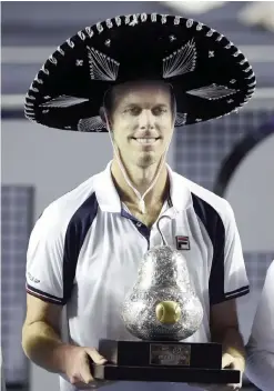  ?? —AFP ?? ACAPULCO: Sam Querrey of the US celebrates with the trophy after beating Rafael Nadal of Spain 6-3, 7-6 (7/3) in the ATP men’s singles finals of the Mexican Tennis Open in Acapulco, Guerrero State, Mexico, on Saturday.