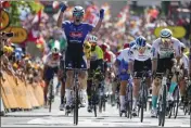  ?? DANIEL COLE — THE ASSOCIATED PRESS ?? Belgium's Jasper Philipsen, left, celebrates as he crosses the finish line ahead of second-placed Germany's Phil Bauhaus, right, to win the third stage of the Tour de France cycling race in Bayonne, France, on Monday.