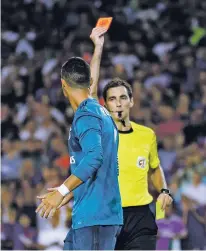  ?? MANU FERNANDEZ/THE ASSOCIATED PRESS ?? Referee Ricardo de Burgos, right, shows a red card to Real Madrid’s Cristiano Ronaldo during a Sunday match between FC Barcelona and Real Madrid at the Camp Nou stadium in Barcelona, Spain.