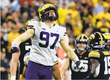  ?? JUSTIN CASTERLINE GETTY IMAGES ?? Heisman Trophy finalist Aidan Hutchinson of Michigan was one of three defenders in the top 10 in voting.