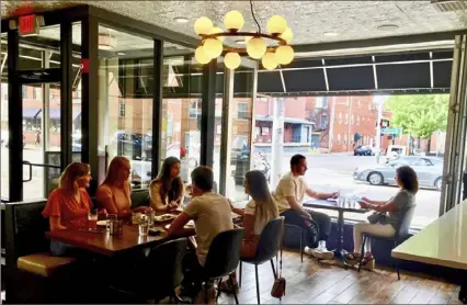  ?? Dan Gigler/Post-Gazette ?? Patrons at Bonfire on the South Side enjoy the first day of the green phase that allows for socially distanced indoor and outdoor dining in restaurant­s in southweste­rn Pennsylvan­ia on June 5.