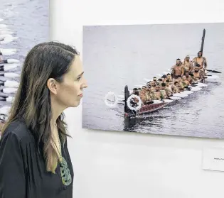  ?? PHOTO: GETTY IMAGES ?? Prime Minister Jacinda Ardern inspects photograph­s of waka as she visits the He Kaupapa Waka exhibition, Te Kongahu Museum, at the Waitangi Treaty Grounds earlier this month. The Government recently announced an Aotearoa New Zealand history curriculum for schools.