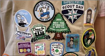  ?? ELAINE THOMPSON, FILE - THE ASSOCIATED PRESS ?? In this 2018 file photo, patches cover the back of a Girl Scout’s vest at a demonstrat­ion of some of their activities in Seattle. Girl Scouts of the United States of America claim the century-old organizati­on is in a “highly damaging” recruitmen­t war with Boy Scouts of America after the group opened its core services to girls, leading to marketplac­e confusion and some girls unwittingl­y joining the Boy Scouts.