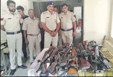  ?? HT PHOTO ?? Police personnel with the licensed weapons deposited by the dera management on Monday.