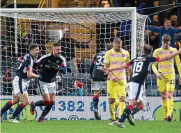  ??  ?? Sickener: Hearts players trudge away after Dundee’s late winner