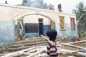  ?? PHOTO BY RASBERT TURNER ?? Residents doing their part in the restoratio­n of the police station in Troja, St Catherine.