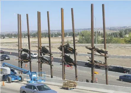  ?? GAVIN YOUNG ?? The Bowfort Towers public art installati­on installed along the Trans Canada Highway near the Bowfort Road interchang­e in Calgary was created using steel beams with Rundle rock suspended within them.