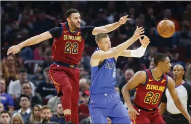  ?? RON SCHWANE — THE ASSOCIATED PRESS ?? Larry Nance Jr., left, and Brandon Knight defend against the Mavericks’ Kristaps Porzingis in the first half Nov. 3.