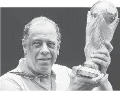  ??  ?? Former Brazilian soccer captain Carlos Alberto Torres holds the 2014 FIFA World Cup Brazil trophy during its unveiling ceremony at a Soccerex event at Copacabana beach in Rio de Janeiro in this Nov 21, 2010 file photo. — Reuters photo