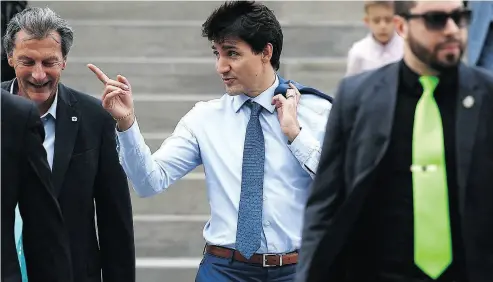 ?? JUSTIN TANG / THE CANADIAN PRESS ?? Prime Minister Justin Trudeau heads to a marijuana legalizati­on news conference on Wednesday in Ottawa.