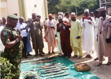  ??  ?? Acting Director of Defence Informatio­n, Brig.-Gen. John Agim (left), displays arms recovered from bandits in Zamfara State yesterday NAN