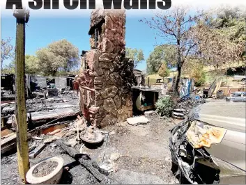  ?? Shelly Thorene
/ Union Democrat ?? The fireplace remains standing near a Honda Pilot that sustained damage from the flames in a blaze on Friday that destroyed a home onyankee Hill Road.