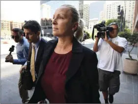  ??  ?? Margaret Hunter (center) the wife of U.S. Rep. Duncan Hunter, arrives for an arraignmen­t hearing on Thursday, in San Diego. AP PHOTO/DENIS POROY