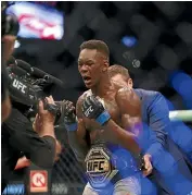  ?? GETTY IMAGES ?? Israel Adesanya celebrates winning the UFC middleweig­ht title against Robert Whittaker.