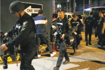  ?? Bullit Marquez / Associated Press ?? SWAT members of the national police arrive at the Resorts World Manila complex after gunshots and explosions rang out. Officials blamed a lone gunman for the violence.