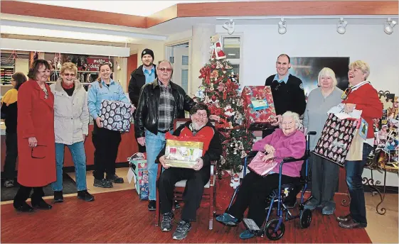  ?? SPECIAL TO THE EXAMINER ?? Every resident at Fairhaven received a Christmas gift from Santa this year including Roy and Elizabeth (both seated) and Jean, second from right. Jay Lough Hayes, far right, who oversees the Santa for Peterborou­gh Seniors program, and her team are shown delivering the gifts, assisted by Brinks Canada employees.