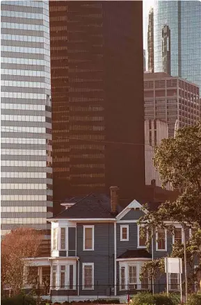  ?? Melissa Phillip / Staff file photos ?? The city will pay to move the blue-and-white wooden Cohn House one block north of Minute Maid. Arthur Cohn, its first resident, helped found what is now Rice University.