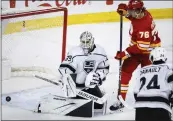  ?? ?? Kings goalie Cam Talbot stops a shot by Calgary's Martin Pospisil during the third period. The Flames scored two goals in the third period for a 4-2victory.
