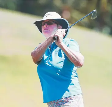  ?? Picture: BRENDAN RADKE ?? GONE: Anne Black hits an iron shot at Paradise Palms, Kewarra Beach.