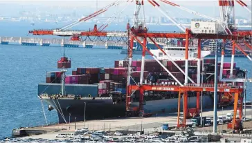  ?? — AP ?? Limited growth: A container ship is seen being loaded at the port of Kawasaki near Tokyo. October imports grew at the fastest pace of 53.5% since 1980 as the yen inflated already elevated commodity prices, while exports gained 25.3%.