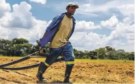  ?? AFP ?? Zimbabwean­s celebrate, top, after the resignatio­n of Robert Mugabe in November. His policy of confiscati­ng white-owned farms, such as the one above, helped ruin the country’s economy