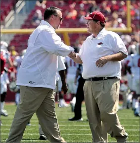  ?? NWA Democrat-Gazette file photo/MICHAEL WOODS ?? Although Coach Bret Bielema and the Arkansas Razorbacks won’t face former offensive coordinato­r Jim Chaney (right) and the Georgia Bulldogs in the regular season, the Hogs will face several of the 13 new SEC coordinato­rs.