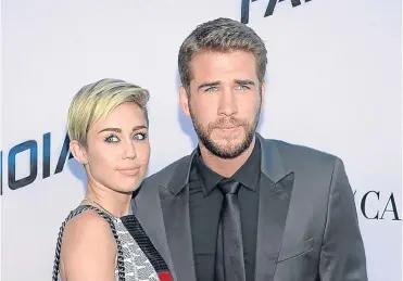  ??  ?? ▼ Miley, who is engaged to Liam Hemsworth, cites godmother Dolly as her style mentor.